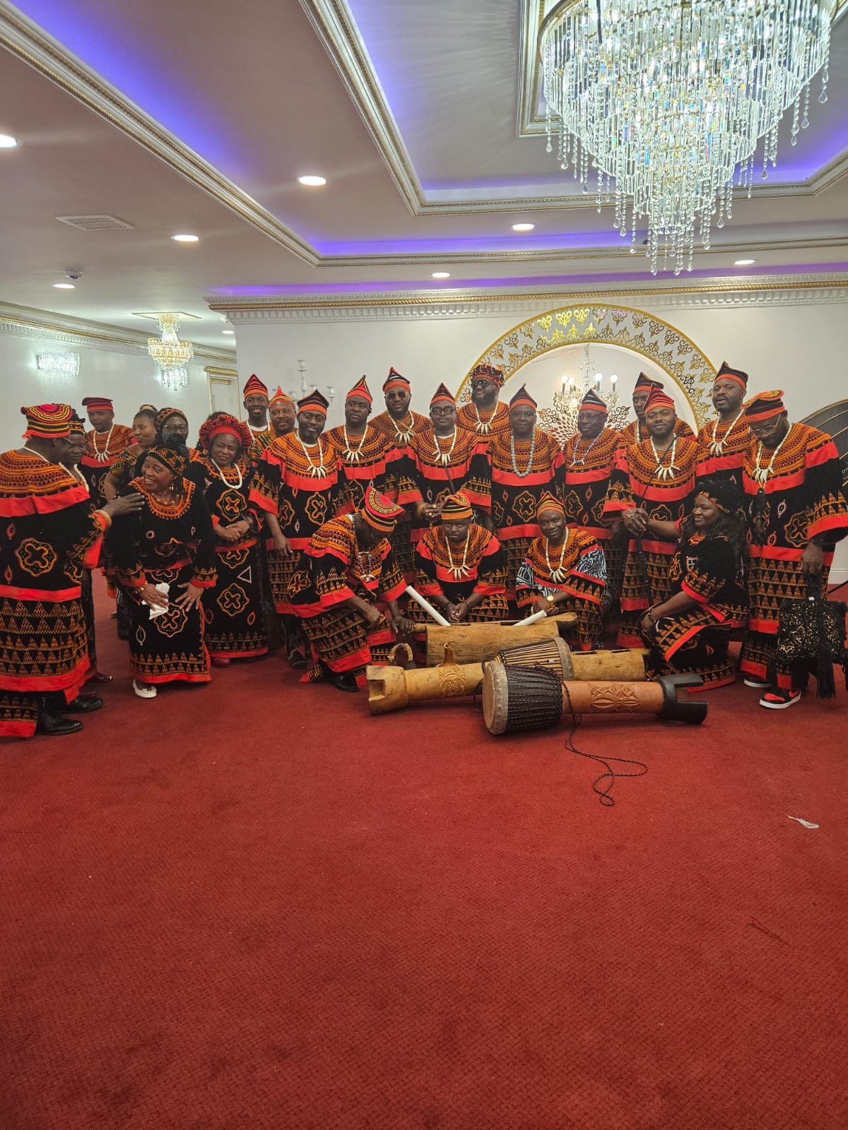 A chief in traditional Nkwen regalia addressing the hall during cultural night