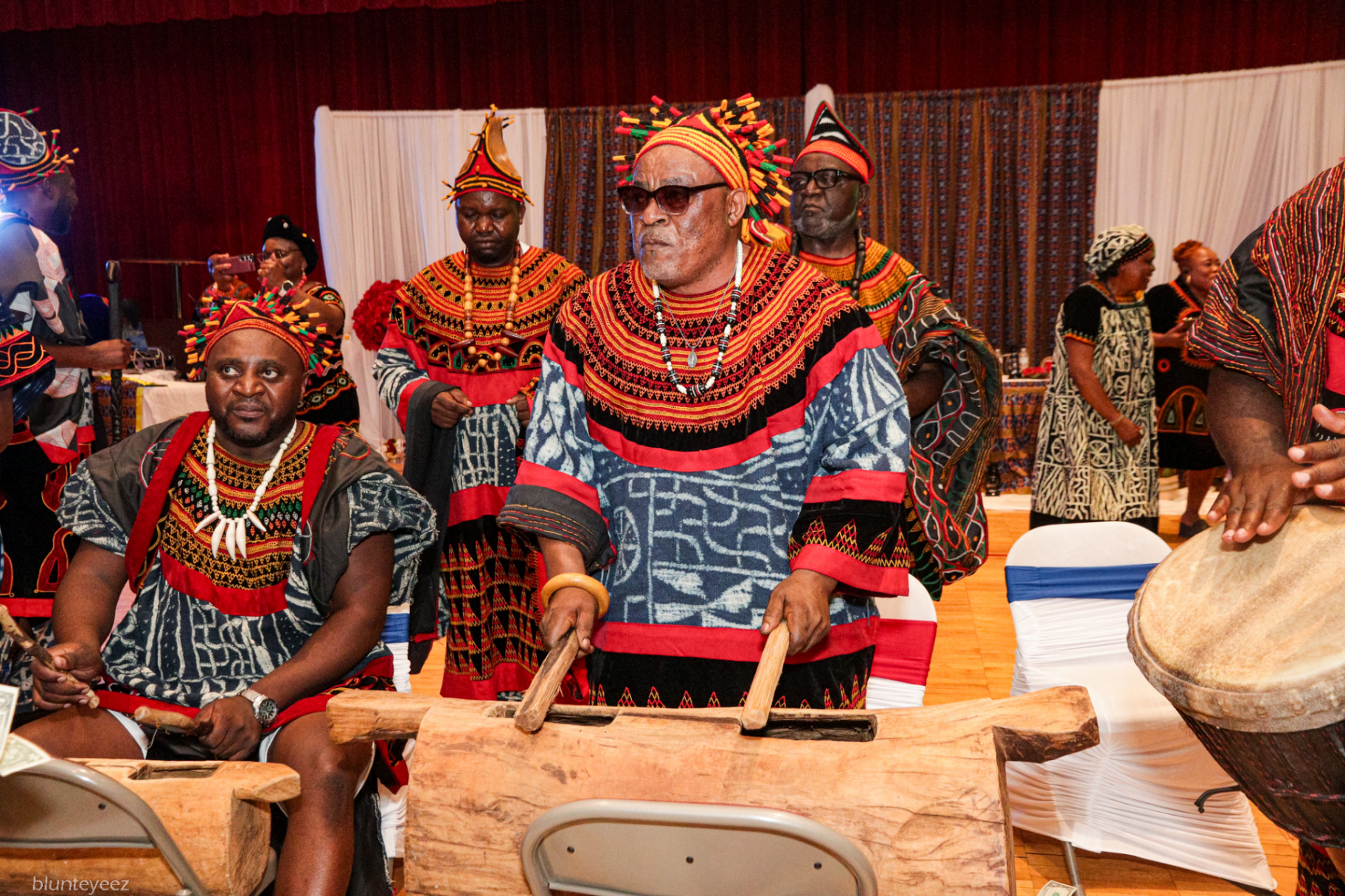 Percussionists playing the carved log drum